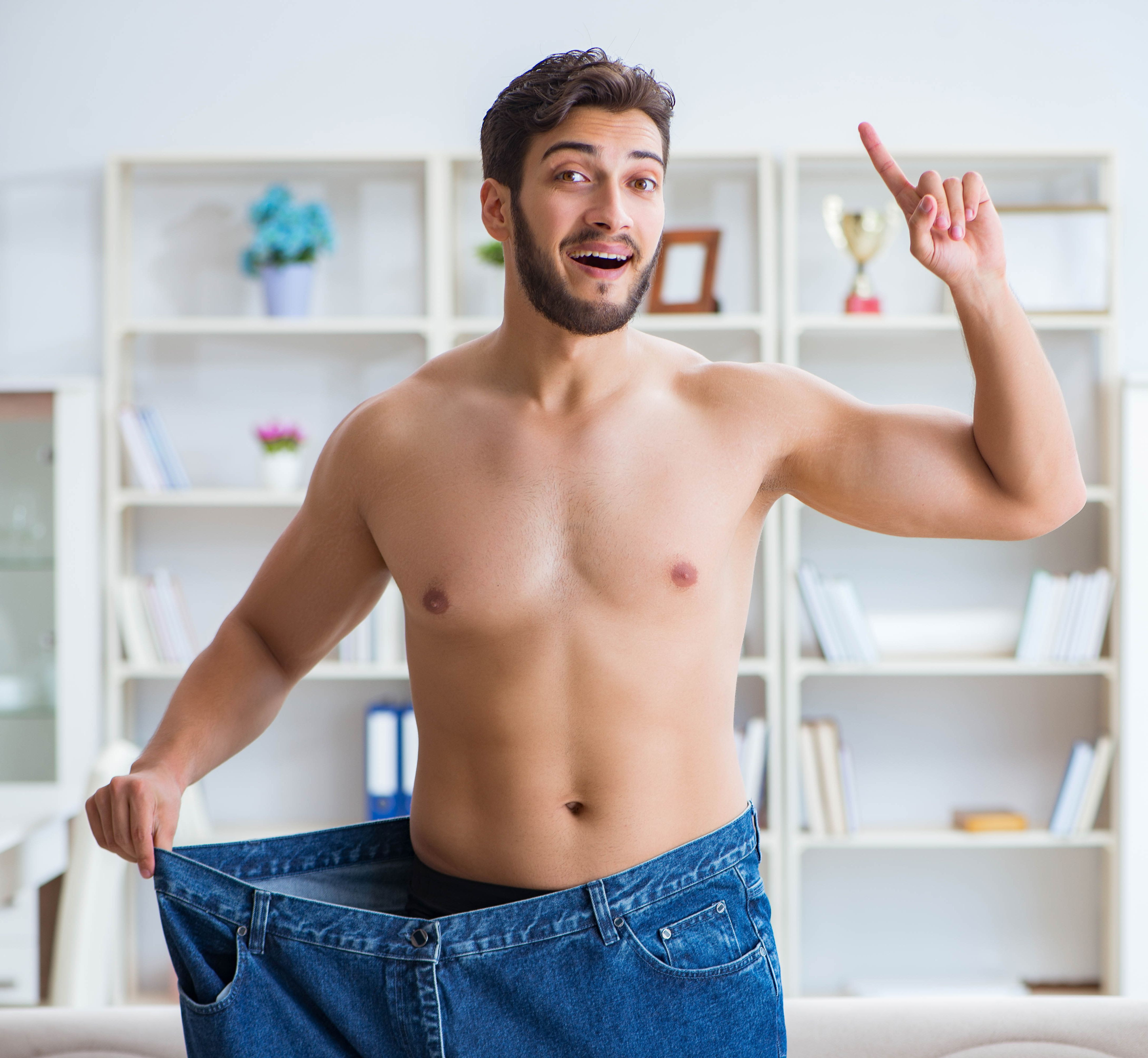 Man in oversized pants in weight loss concept